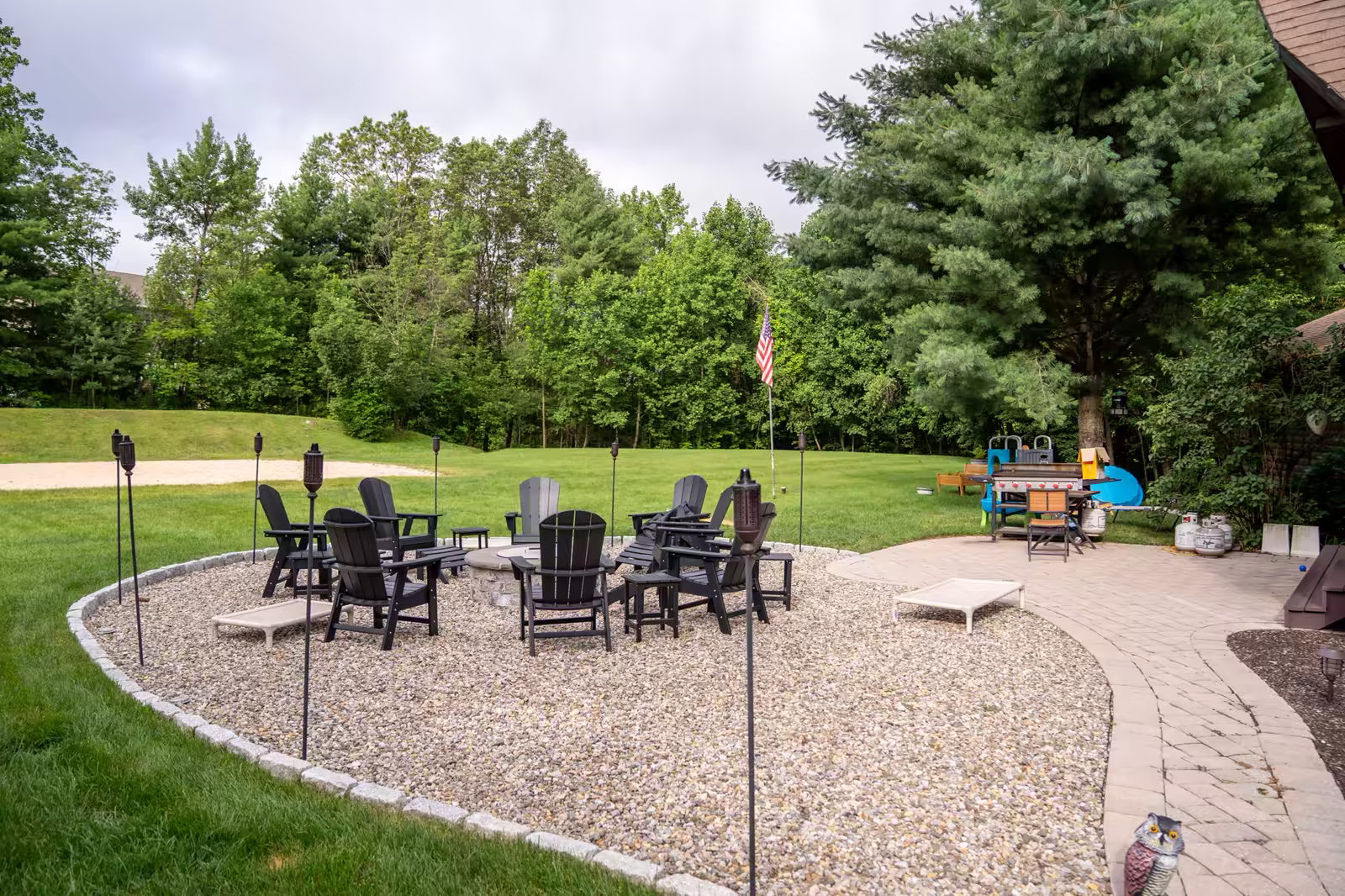 The fire-pit courtyard at The Maddie Ranch, ringed with Adirondack chairs