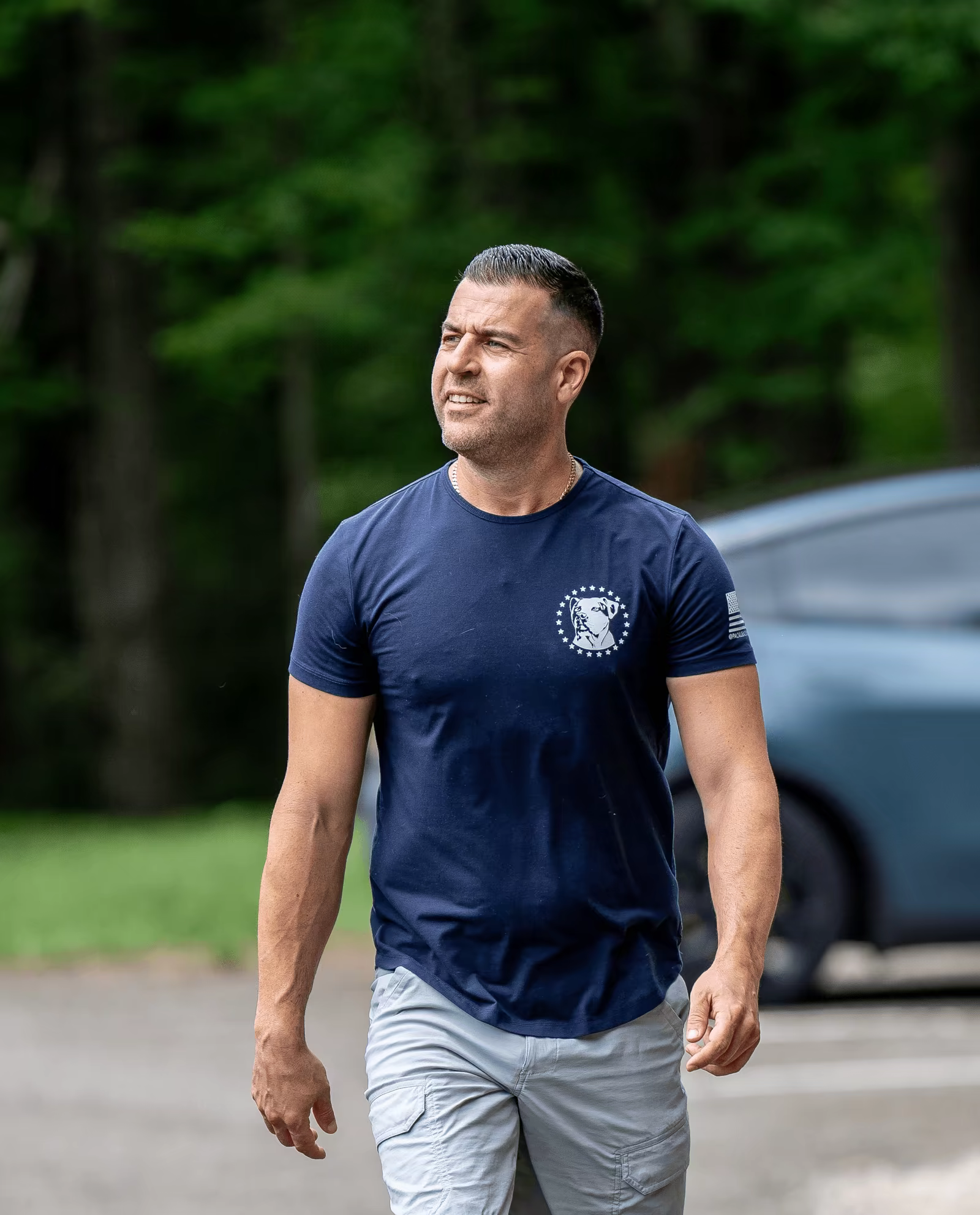 Steve Del Savio walking the grounds of the ranch in a navy tee
